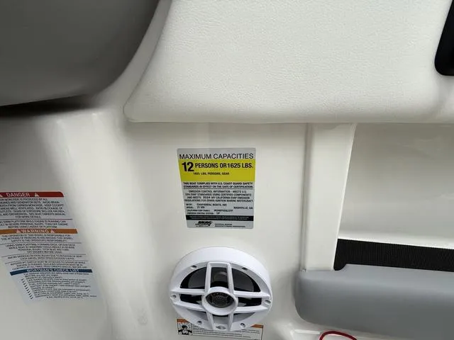 Slide: The Image of 2024 Chaparral 21 SSi boat interior showing capacity label and speaker. - 12