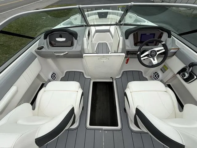 Slide: The Image of 2024 Chaparral 21 SSi boat interior with white seating and modern dashboard. - 15