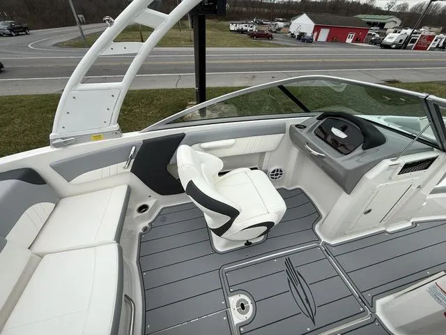 Slide: The Image of 2024 Chaparral 21 SSi boat interior with sleek seating and modern dashboard design. - 9