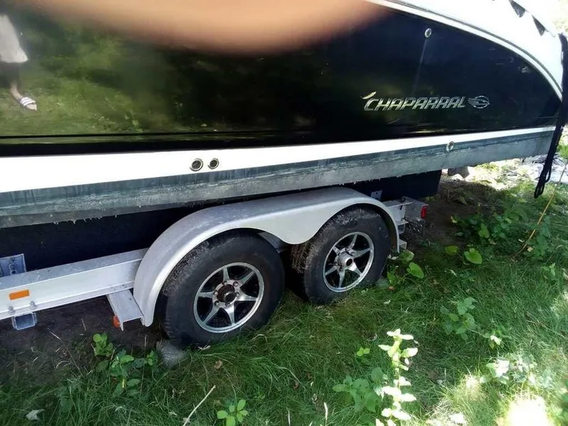 Slide: The Image of Chaparral 276ssx 2010 boat on trailer, parked on grass. - 2