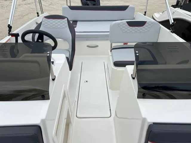 Slide: The Image of 2024 Bayliner Element M19 boat interior with dual consoles and seating. - 15