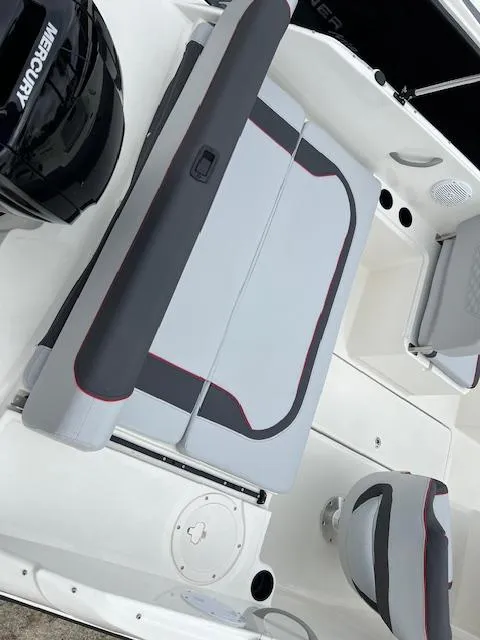 Slide: The Image of 2024 Bayliner Element M19 boat interior with Mercury engine and seating. - 4