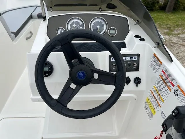 Slide: The Image of 2024 Bayliner Element M19 boat dashboard with steering wheel and control panel. - 9