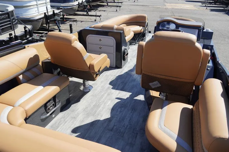 Slide: The Image of 2024 Crest Savannah 250 SLSC CP3 boat interior with tan leather seating and modern dashboard. - 5