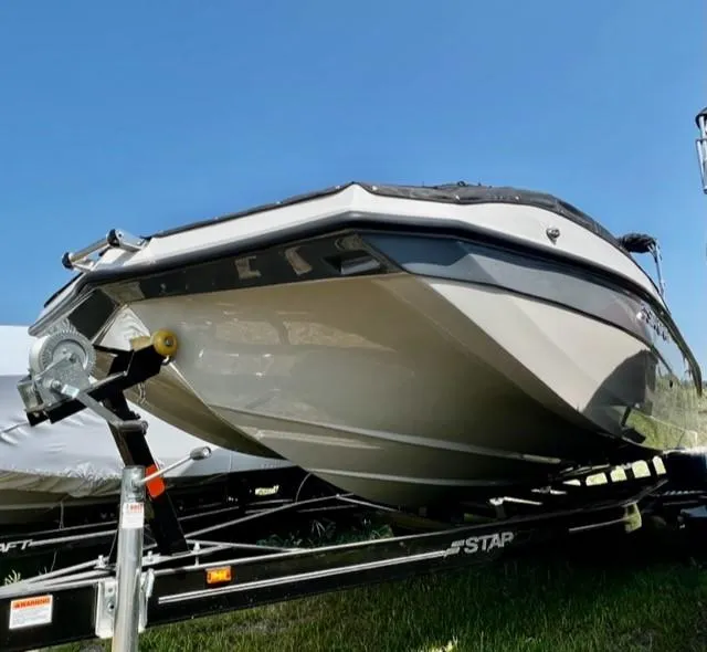 Slide: The Image of 2024 Starcraft SVX211 boat on a trailer under a clear blue sky. - 1