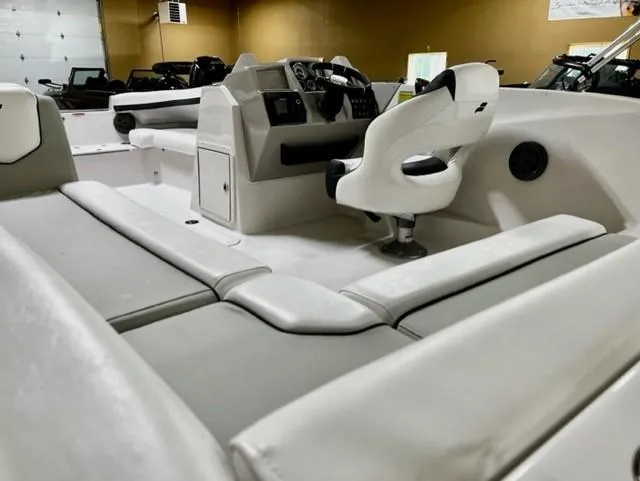 Slide: The Image of 2024 Starcraft SVX211 boat interior with white seating and modern dashboard. - 6
