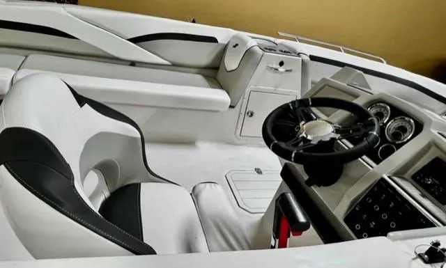 Slide: The Image of 2024 Starcraft SVX211 boat interior with sleek steering wheel and modern dashboard design. - 7