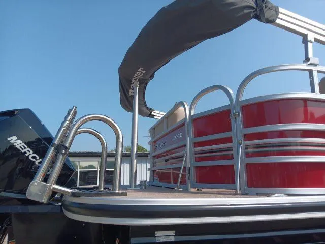 Slide: The Image of 2023 Ranger Reata 223C pontoon boat with red exterior and Mercury engine. - 30