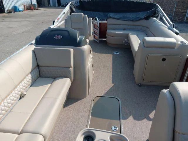 Slide: The Image of 2023 Ranger Reata 223C pontoon boat interior with beige seating and spacious layout. - 32