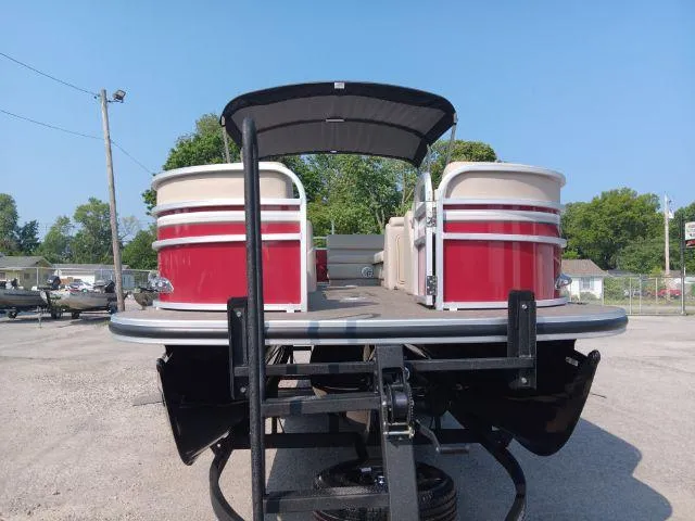 Slide: The Image of 2023 Ranger Reata 223C pontoon boat on trailer, red and white design, outdoor setting. - 35