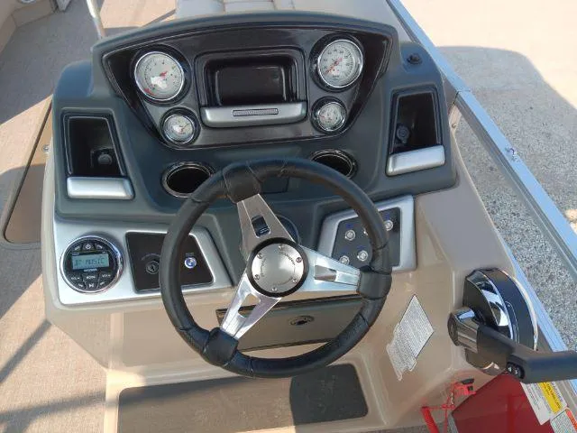 Slide: The Image of 2023 Ranger Reata 223C boat dashboard with steering wheel and control panel. - 37