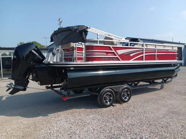 Slide: The Image of 2023 Ranger Reata 223C pontoon boat on trailer, featuring red and black design. - 4
