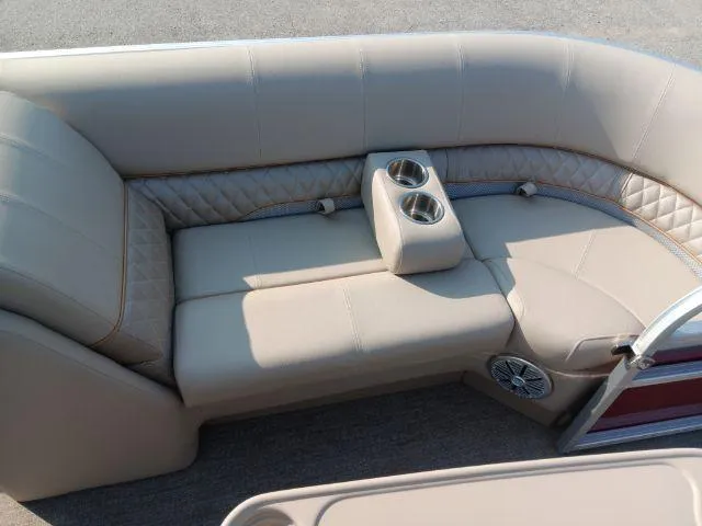 Slide: The Image of 2023 Ranger Reata 223C boat interior with beige seating and cup holders. - 41
