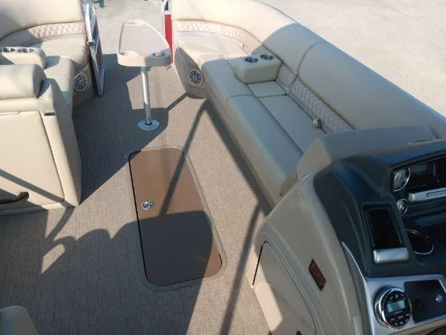 Slide: The Image of 2023 Ranger Reata 223C boat interior with beige seating and control panel. - 42