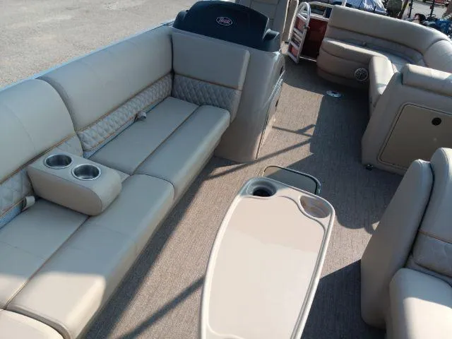 Slide: The Image of 2023 Ranger Reata 223C pontoon boat interior with beige seating and cup holders. - 44