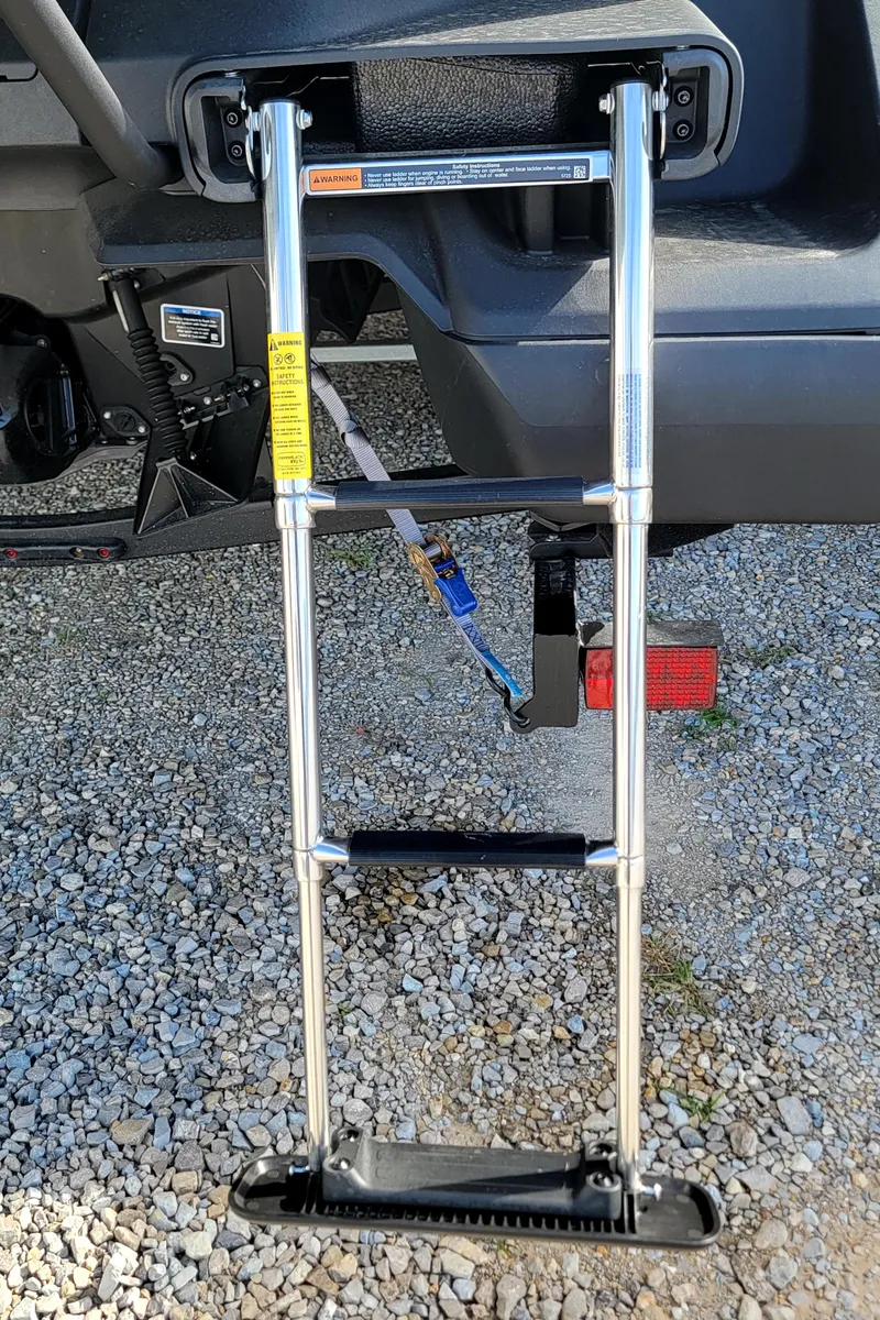 Slide: The Image of 2023 Sea-Doo Switch Sport 21 retractable boarding ladder on gravel. - 12