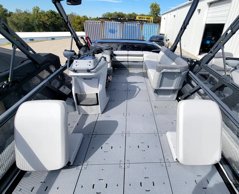 Slide: The Image of 2023 Sea-Doo Switch Sport 21 interior, spacious deck with seating and control console. - 2