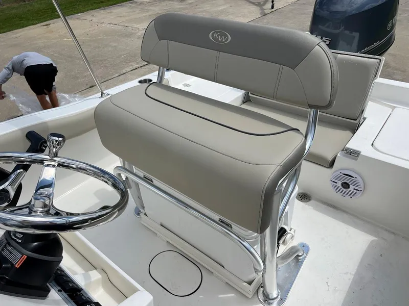 Slide: The Image of 2024 Key West 179 FS boat interior with steering wheel and cushioned seating. - 12
