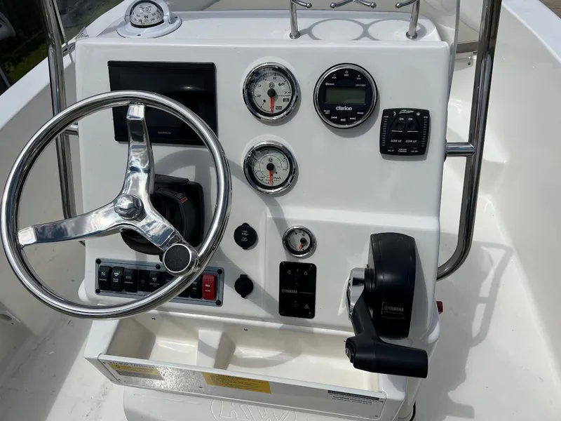 Slide: The Image of 2024 Key West 179 FS boat dashboard with steering wheel and gauges. - 14