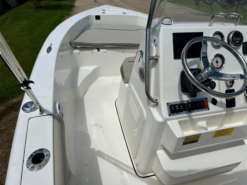 Slide: The Image of 2024 Key West 179 FS boat interior with steering console and seating. - 15