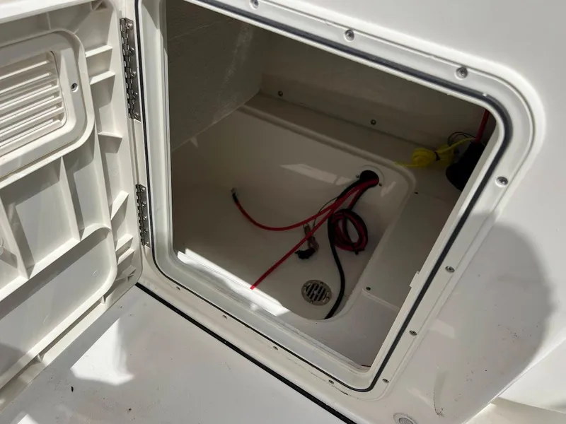 Slide: The Image of Open storage compartment of 2024 Key West 179 FS boat with wiring inside. - 16