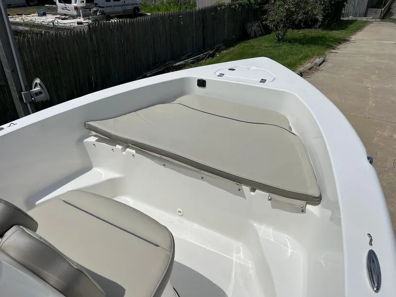 Slide: The Image of 2024 Key West 179 FS boat interior with beige seating and white deck. - 17