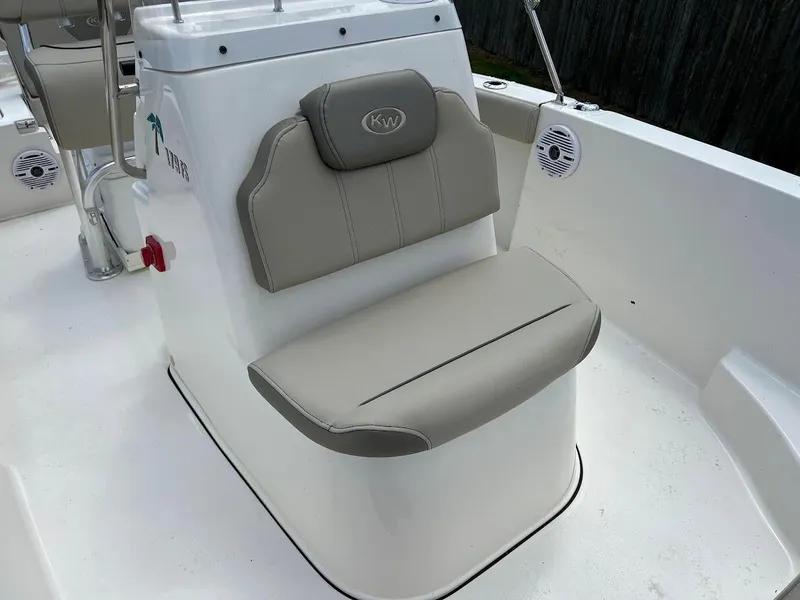 Slide: The Image of 2024 Key West 179 FS boat seat with beige upholstery and KW logo. - 19