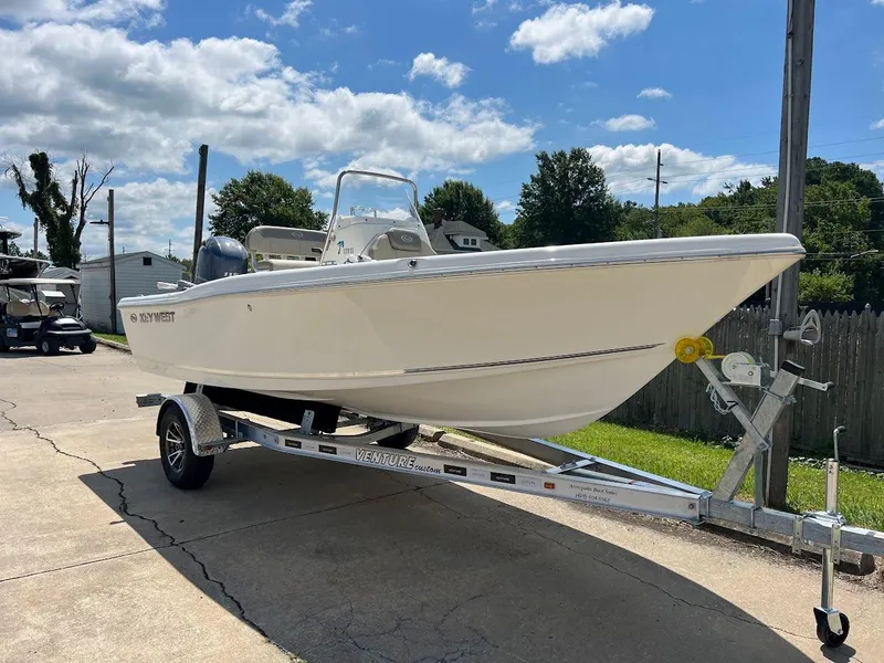 Slide: The Image of 2024 Key West 179 FS boat on a trailer under a sunny sky. - 2