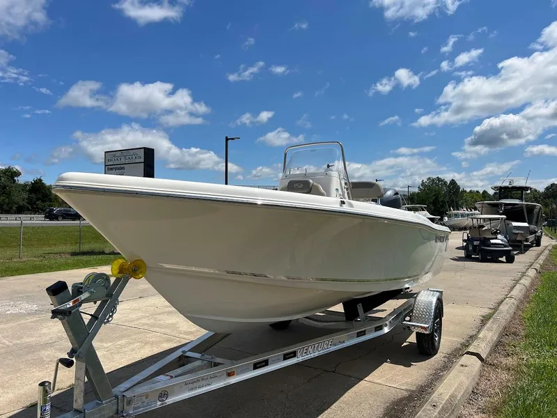Slide: The Image of 2024 Key West 179 FS boat on trailer under a clear blue sky. - 3