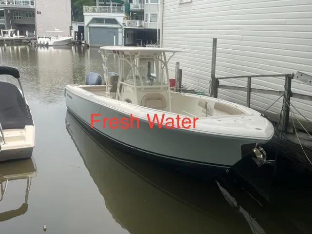 The Image of 2015 Sailfish 320 CC boat docked in fresh water marina. - 0