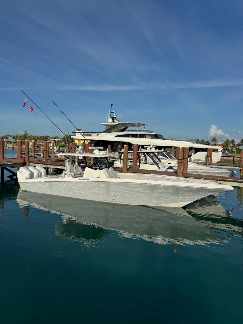 Slide: The Image of 2024 Fountain 38 Tournament Edition boat docked at marina under clear blue sky. - 0