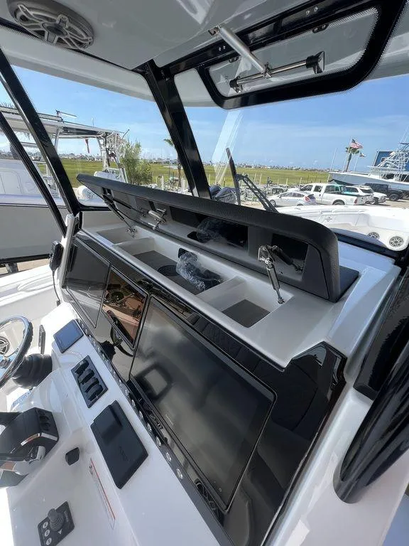 Slide: The Image of 2024 Fountain 38 TE boat dashboard with modern navigation equipment and controls. - 15