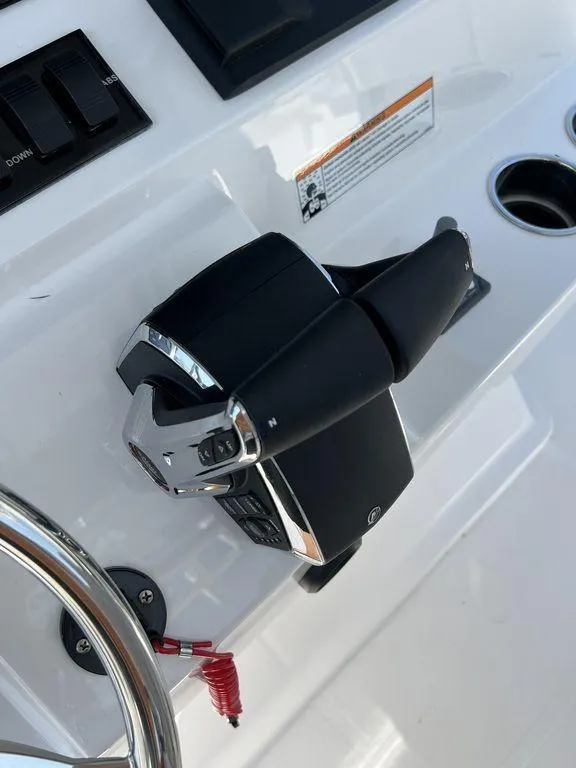 Slide: The Image of 2024 Fountain 38 TE boat throttle controls on a sleek white dashboard. - 18