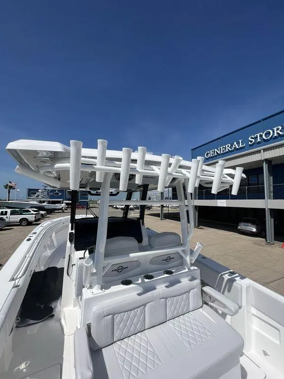 Slide: The Image of 2024 Fountain 38 TE boat with rod holders, docked near a general store. - 22
