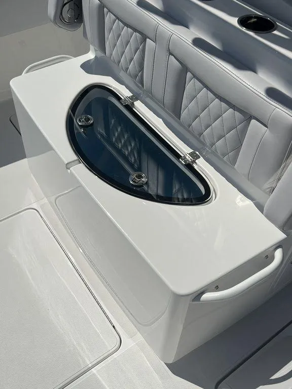 Slide: The Image of 2024 Fountain 38 TE boat seating with integrated storage and cup holders. - 27