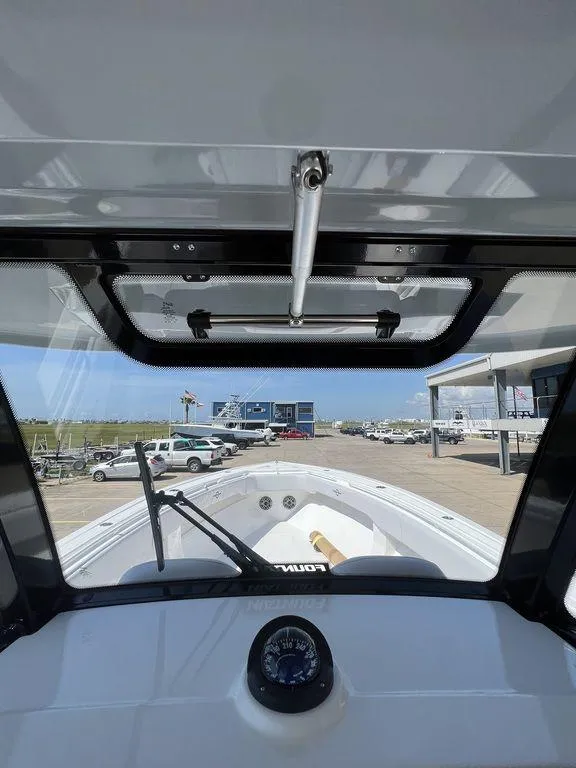 Slide: The Image of 2024 Fountain 38 TE boat interior view with compass and windshield. - 28