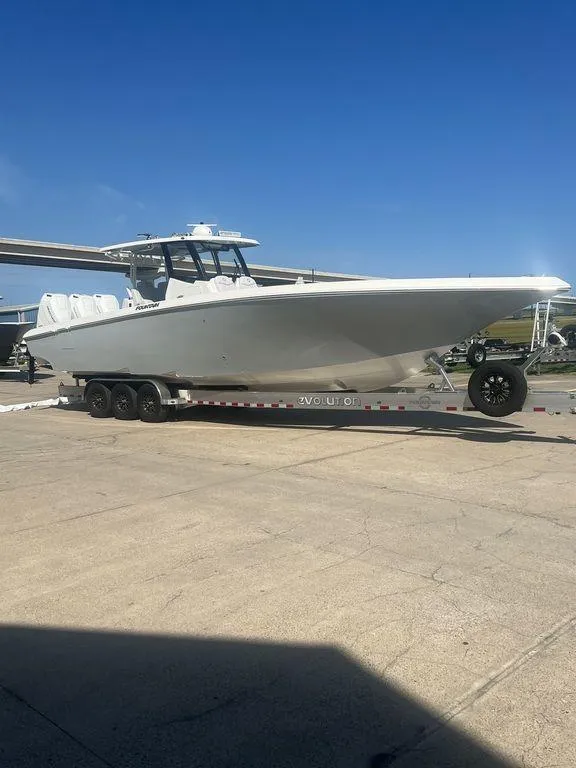 Slide: The Image of 2024 Fountain 38 TE boat on trailer under clear blue sky. - 3