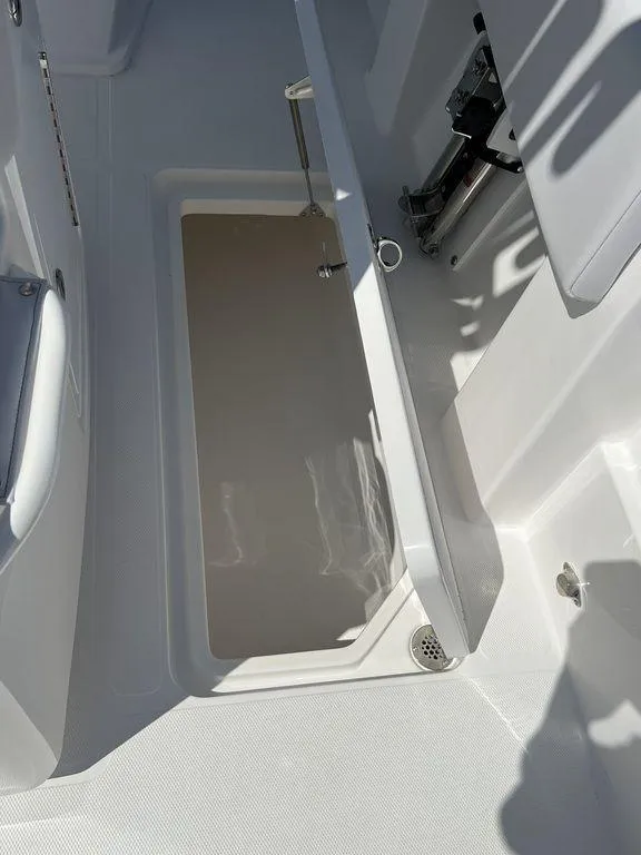 Slide: The Image of 2024 Fountain 38 TE boat interior storage compartment with open hatch. - 33