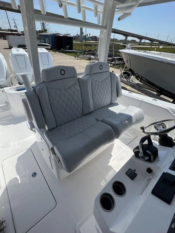 Slide: The Image of 2024 Fountain 38 TE boat interior with dual gray quilted seats and control panel. - 39