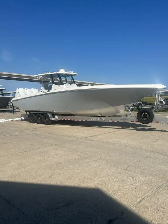 Slide: The Image of 2024 Fountain 38 TE boat on trailer under clear blue sky. - 4
