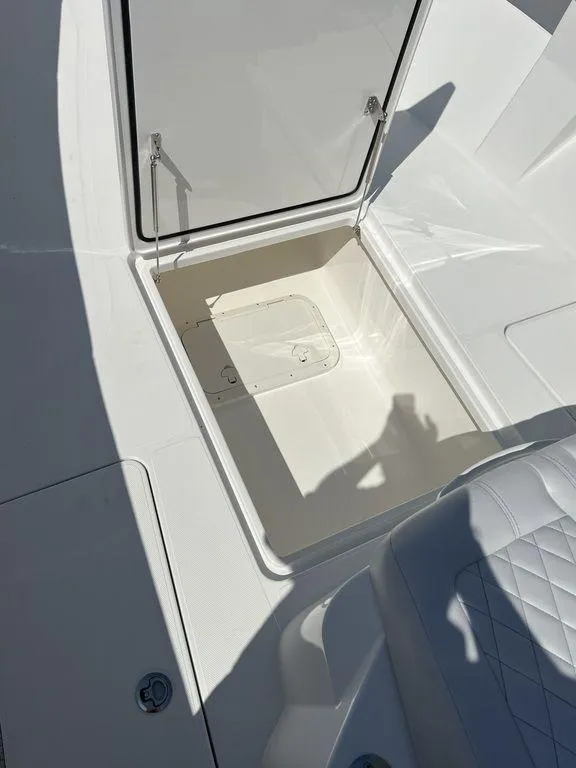 Slide: The Image of 2024 Fountain 38 TE boat storage compartment with open hatch, showcasing interior space. - 44
