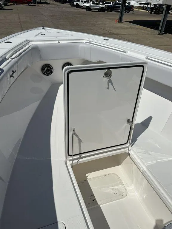 Slide: The Image of 2024 Fountain 38 TE boat interior with open storage compartment and sleek white design. - 47