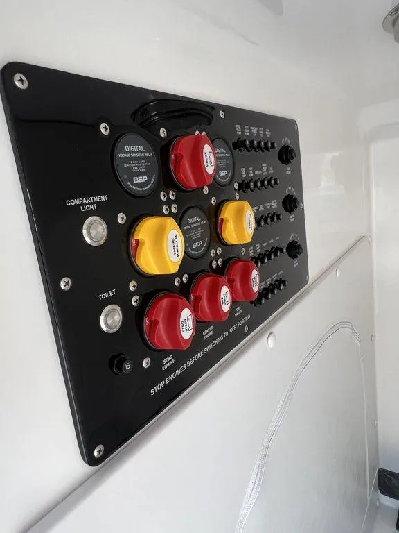 Slide: The Image of Control panel of 2024 Fountain 38 TE boat with switches and dials. - 49