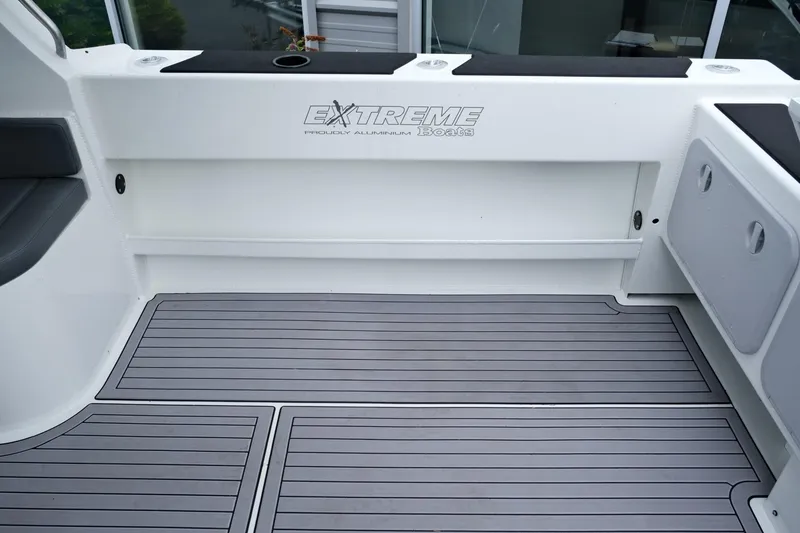 Slide: The Image of 2023 Extreme Boats 745 Game King interior with sleek flooring and storage compartments. - 11