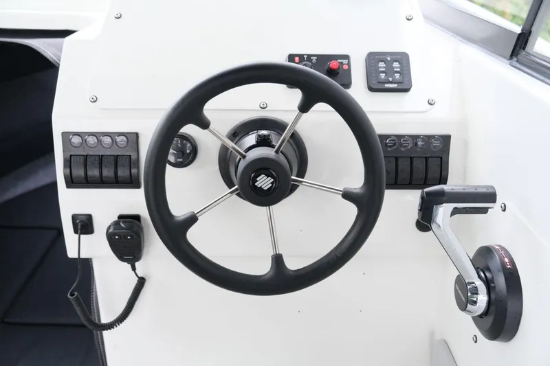 Slide: The Image of 2023 Extreme Boats 745 Game King helm with steering wheel and controls. - 14
