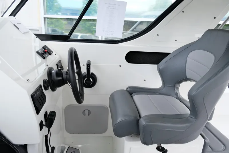 Slide: The Image of Interior of 2023 Extreme Boats 745 Game King, featuring steering wheel and captain's chair. - 15