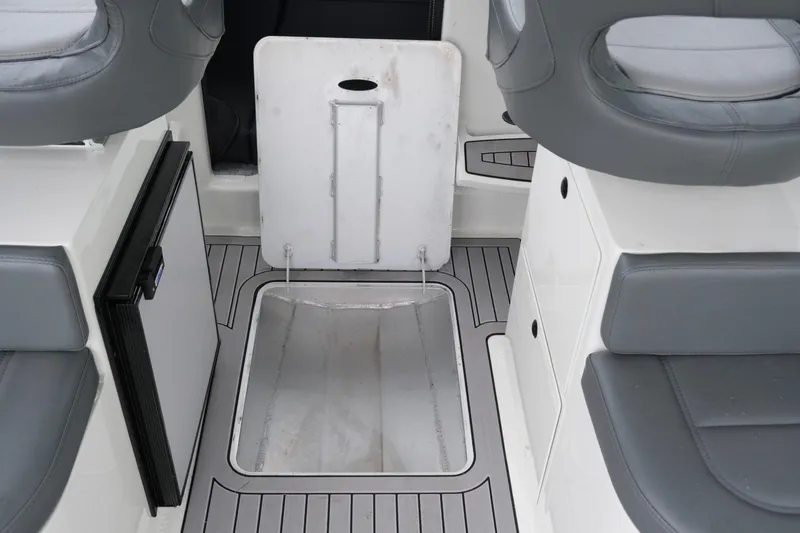Slide: The Image of 2023 Extreme Boats 745 Game King interior with seating and storage compartment. - 19