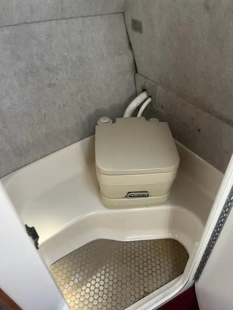 Slide: The Image of 1996 Sea Ray Sundancer boat bathroom with compact portable toilet. - 10