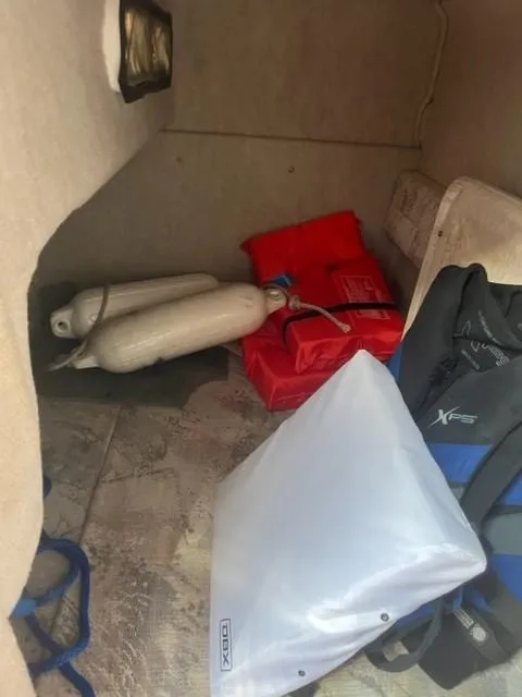 Slide: The Image of Storage area in 1996 Sea Ray Sundancer with life jackets and equipment. - 12