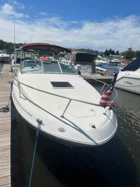 Slide: The Image of 1996 Sea Ray Sundancer docked at marina under clear sky. - 3